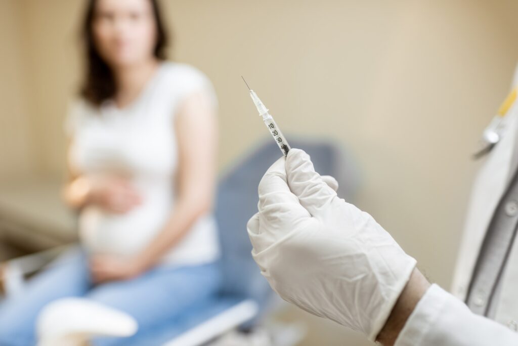Doctor holding vaccine or some medication in the syringe